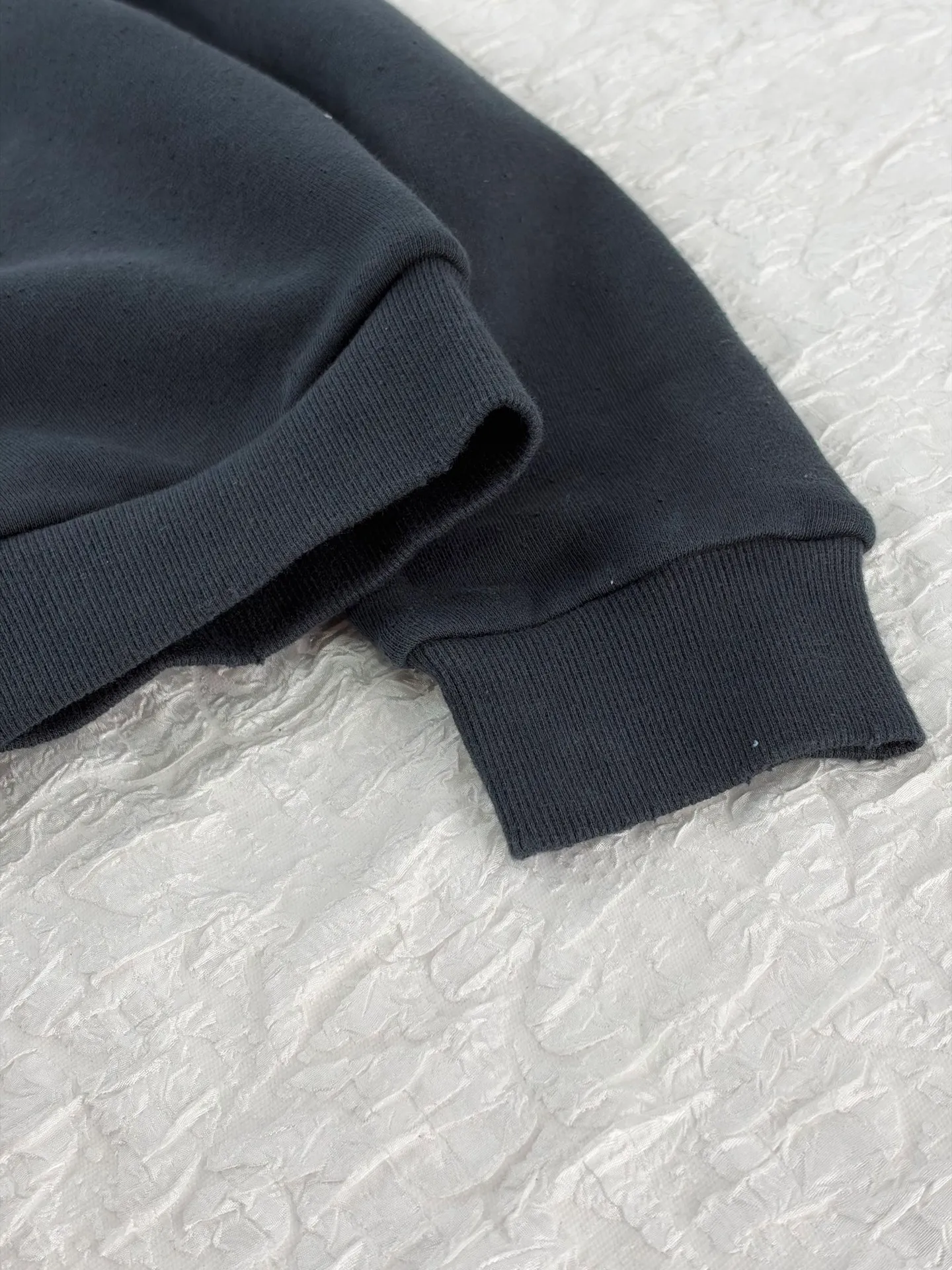 Acne Studio distressed washed zipper baseball sweatshirt is made of 100% cotton terry cloth, garment washed + distressed and sanded. The body adopts dropped shoulder sleeves, a loose oversize silhouette, a V-shaped ribbed baseball collar design, and the edge of the collar is deliberately frayed and damaged. The main zipper is made of distressed metal zipper, and the front panel is positioned with glue crack printing. Size: S/M/L/XL